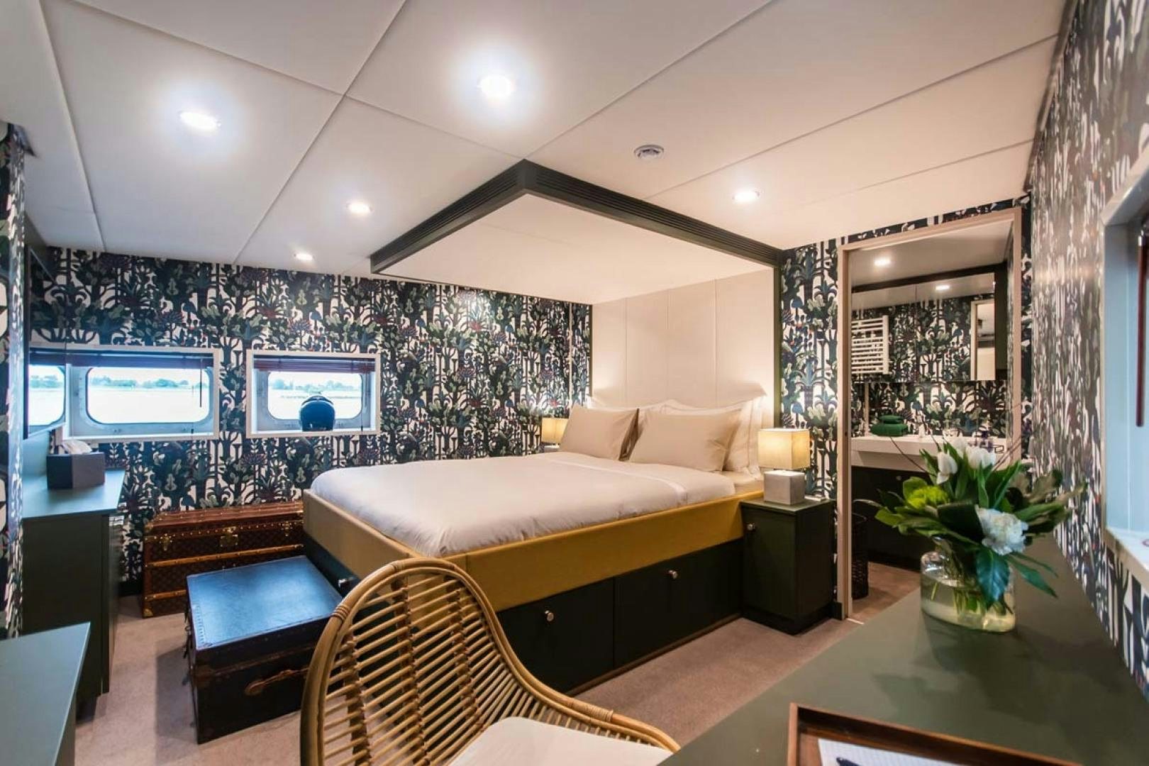 a room with a couch and a table and a tv aboard BAD COMPANY SUPPORT Yacht for Charter