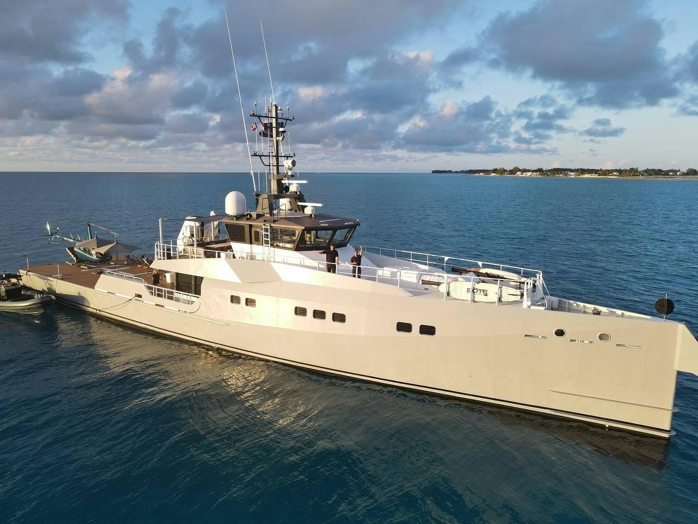 a large white boat in the water aboard BAD COMPANY SUPPORT Yacht for Charter