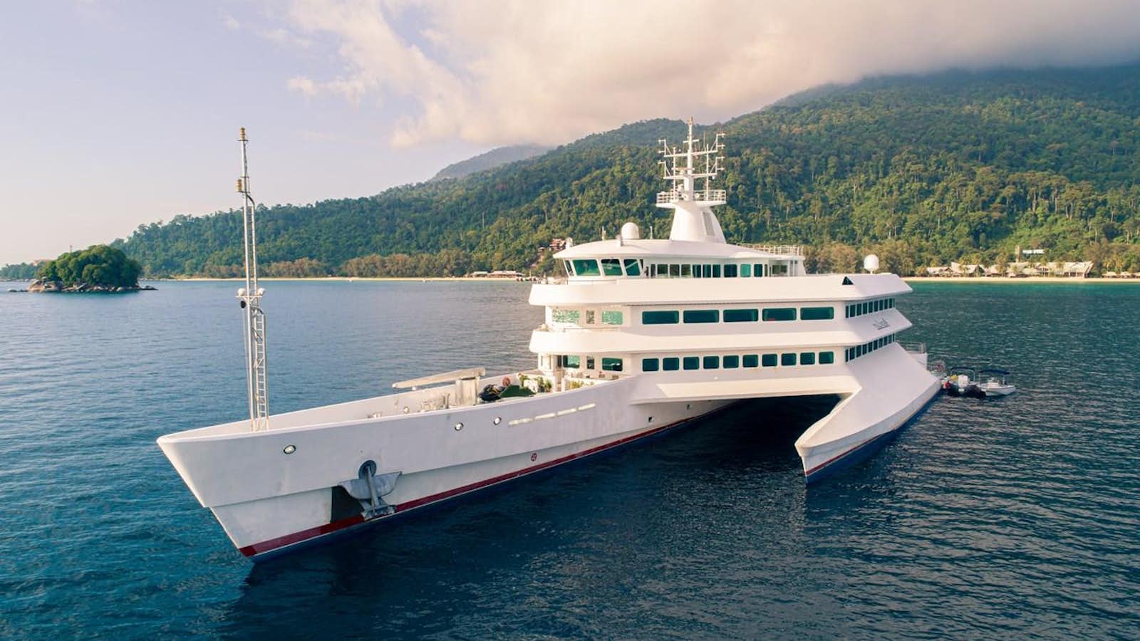 a large white boat in the water aboard ASEAN LADY Yacht for Sale