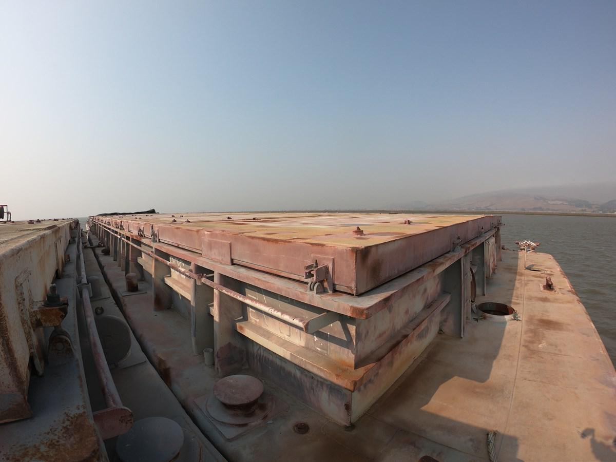 a large wooden boat on a dock aboard BARGES Yacht for Sale