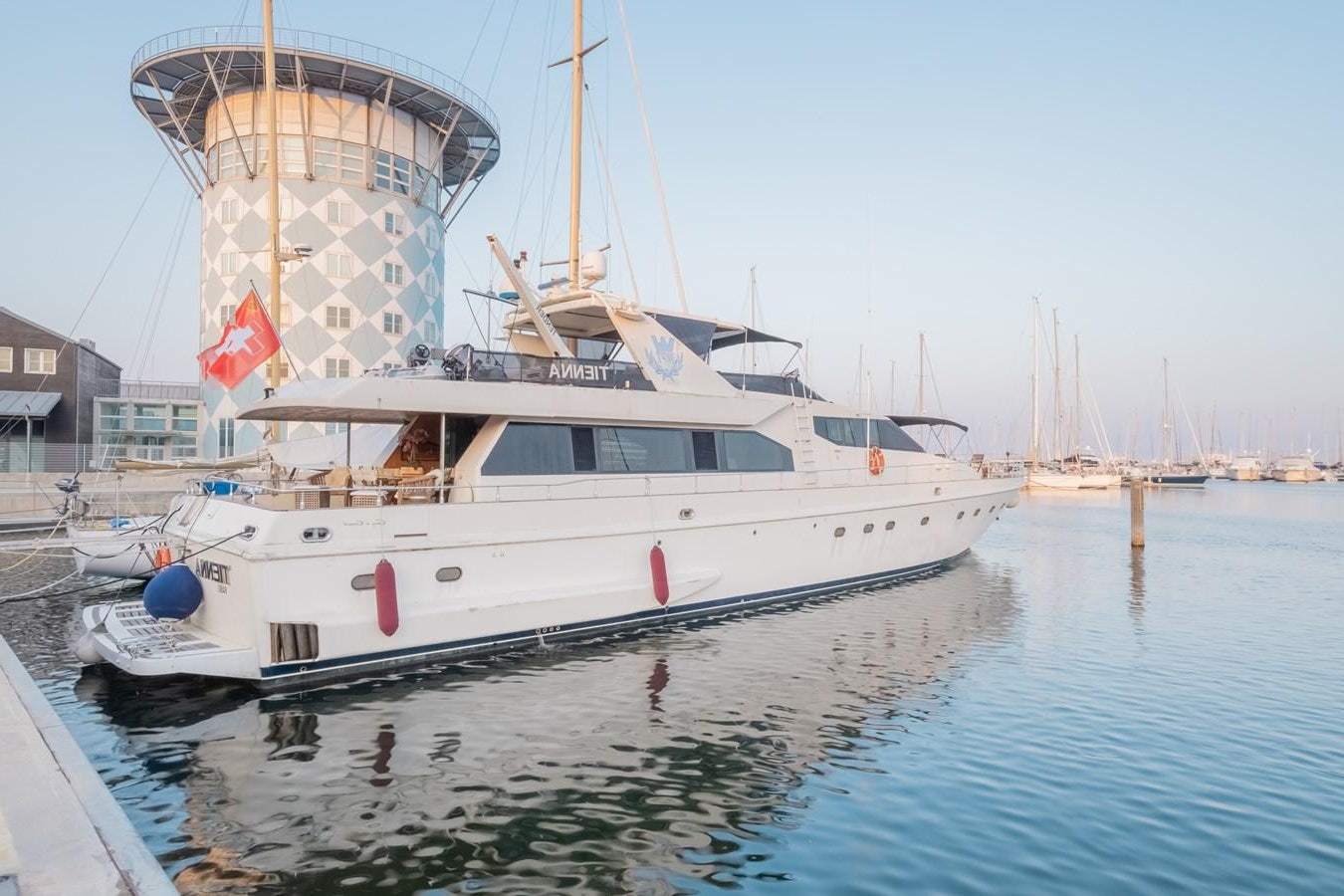 a large white boat in the water aboard TIENNA Yacht for Sale