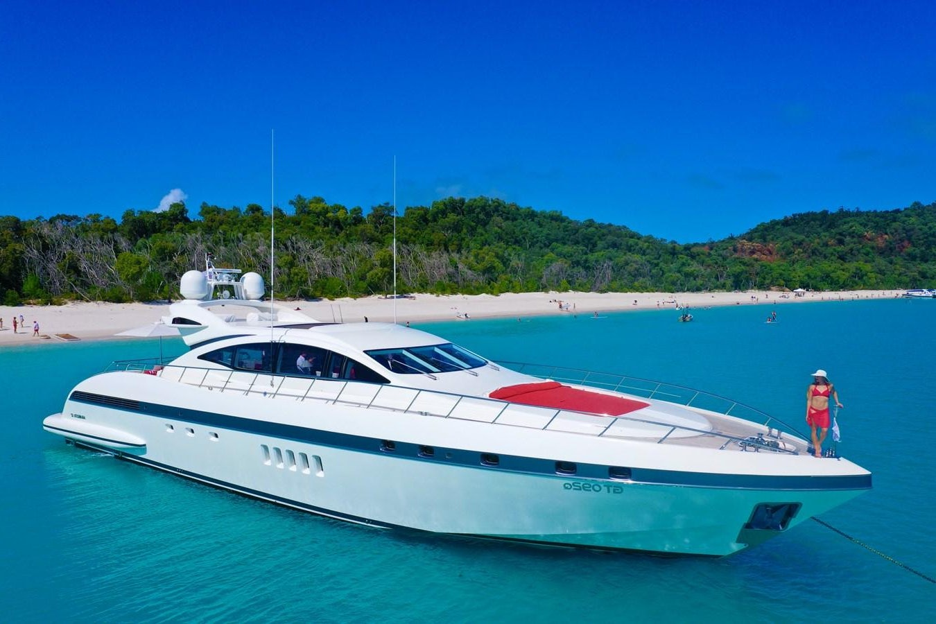 a white yacht on a beach aboard VANISH Yacht for Sale