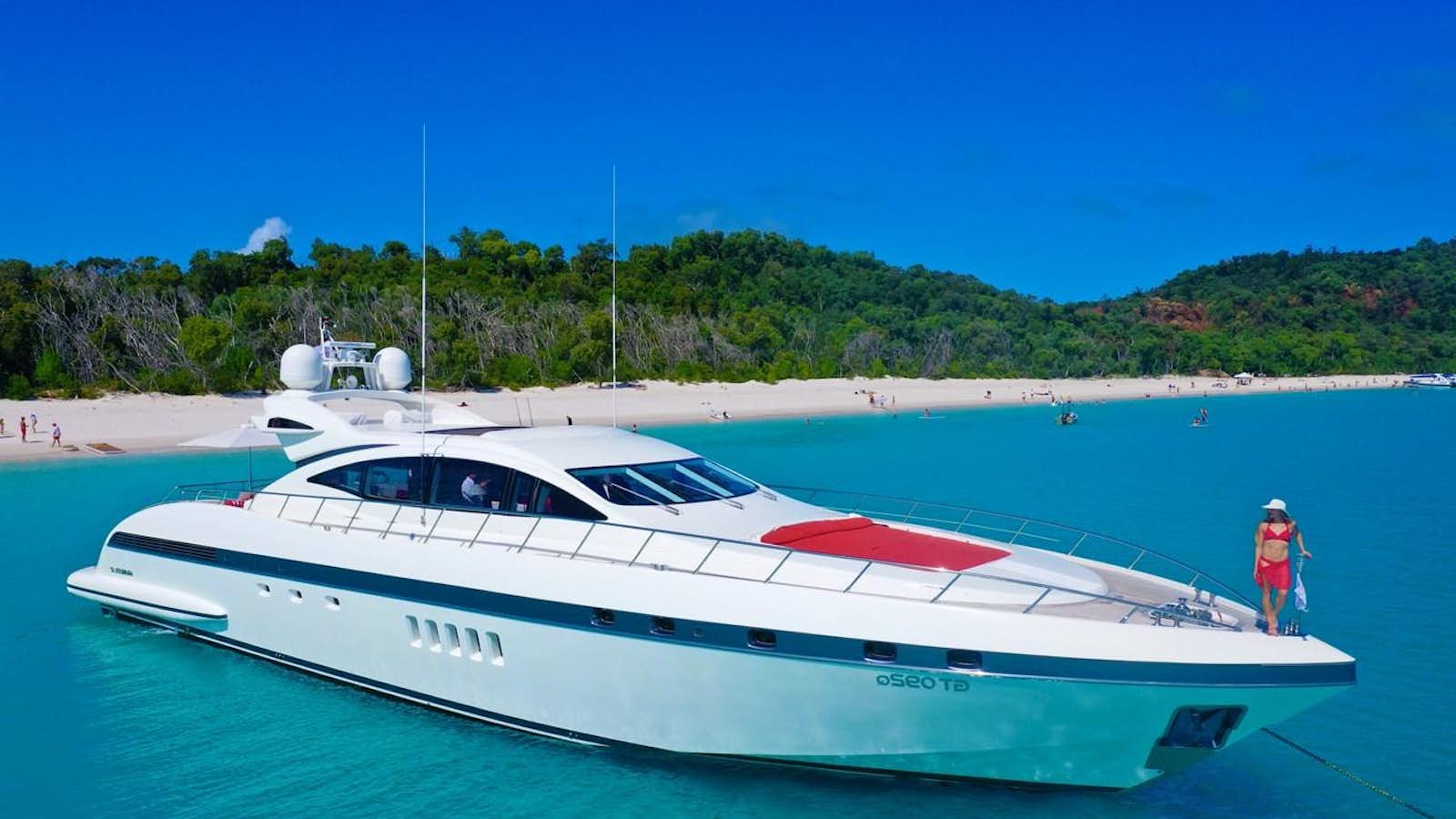 a white yacht on a beach aboard VANISH Yacht for Sale