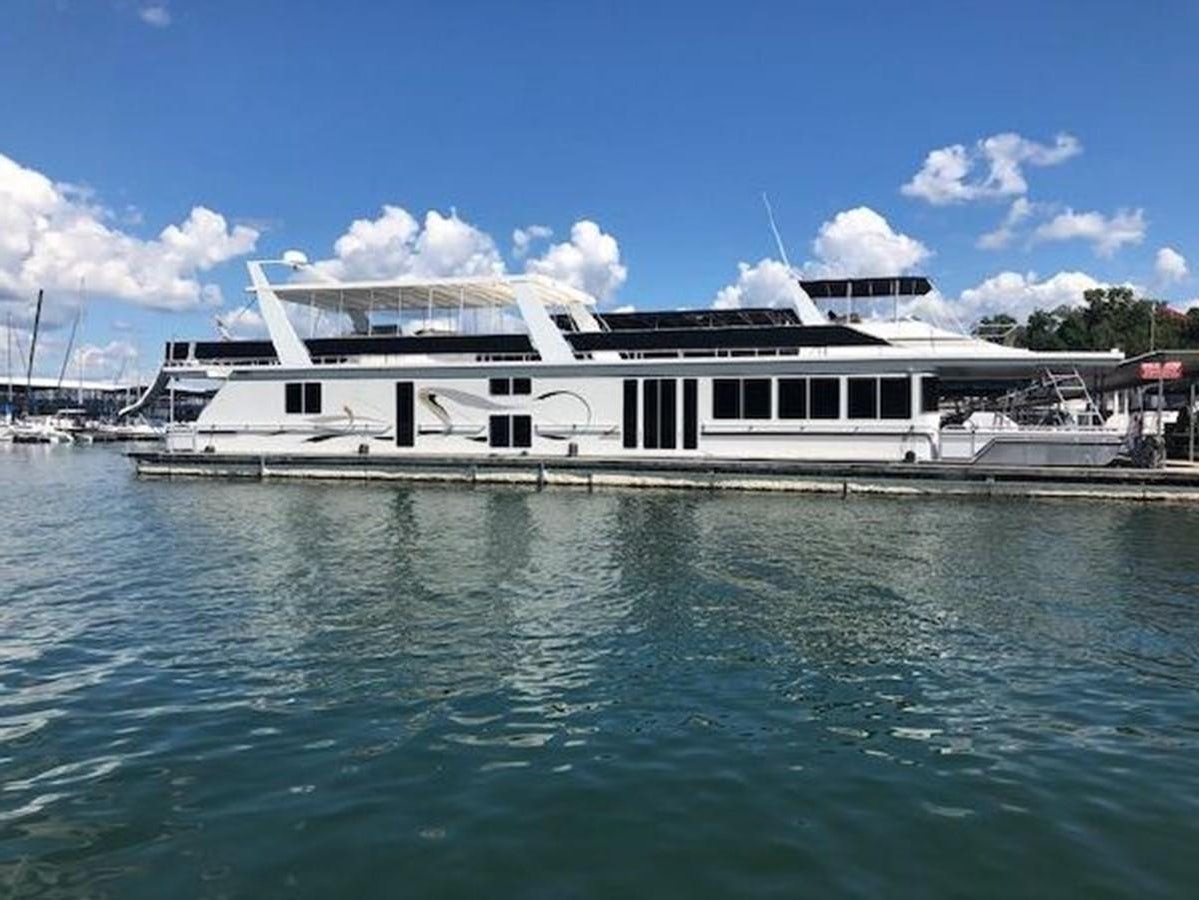 a large white boat in the water aboard FANTASY HOUSEBOAT Yacht for Sale