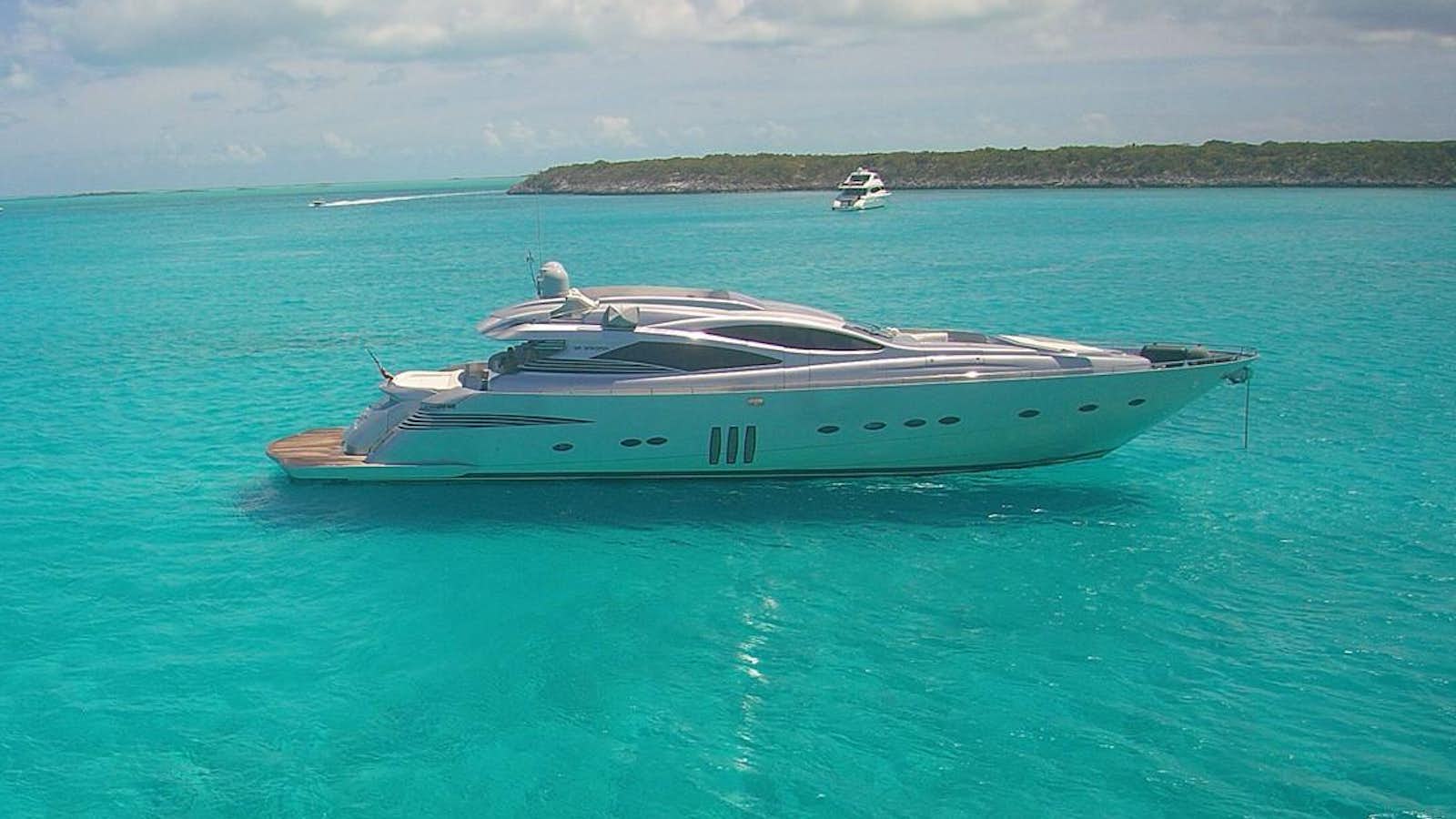 a boat in the water with Lady Musgrave Island in the background aboard YCM 90 Yacht for Sale