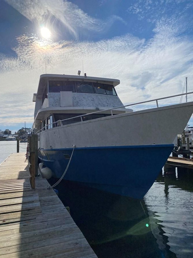 a boat docked at a pier aboard THE OASIS Yacht for Sale