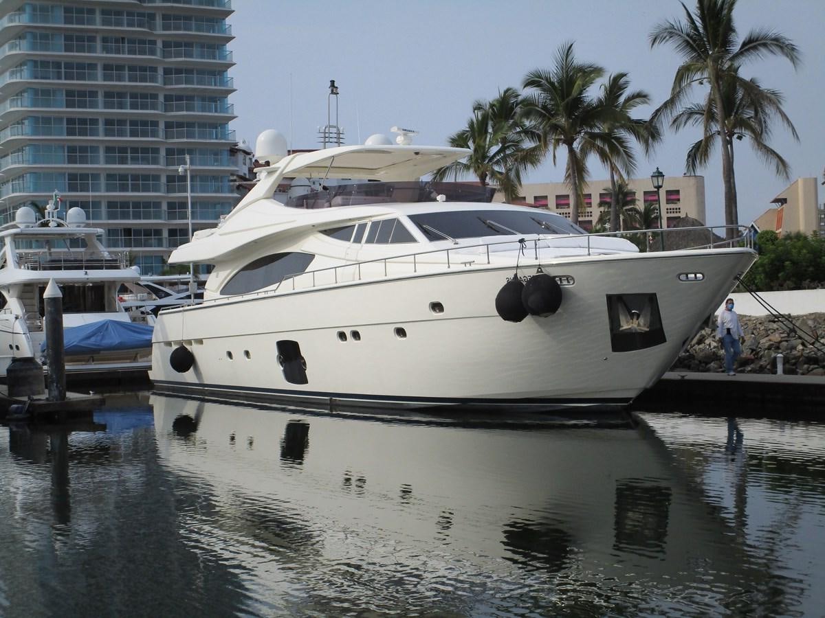 a white yacht docked at a pier aboard NACL Yacht for Sale