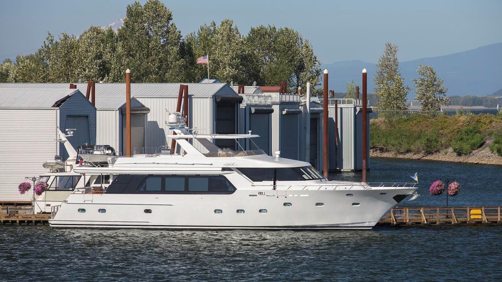 a large white boat in a harbor aboard SILVER WINGS Yacht for Sale