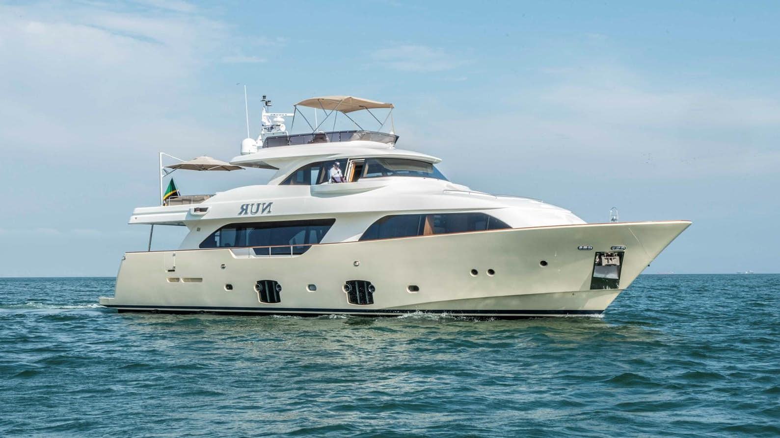 a white boat in the water aboard NUR Yacht for Sale