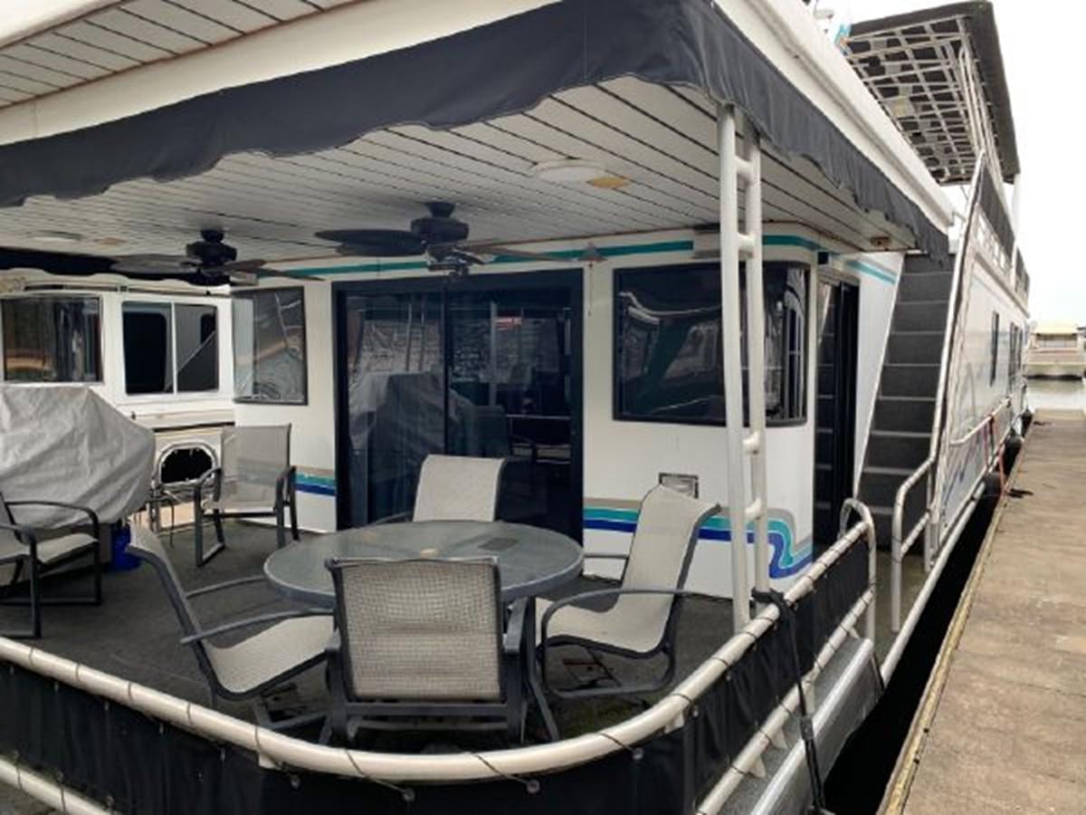 a tram with a table and chairs aboard SUMERSET HOUSEBOAT Yacht for Sale