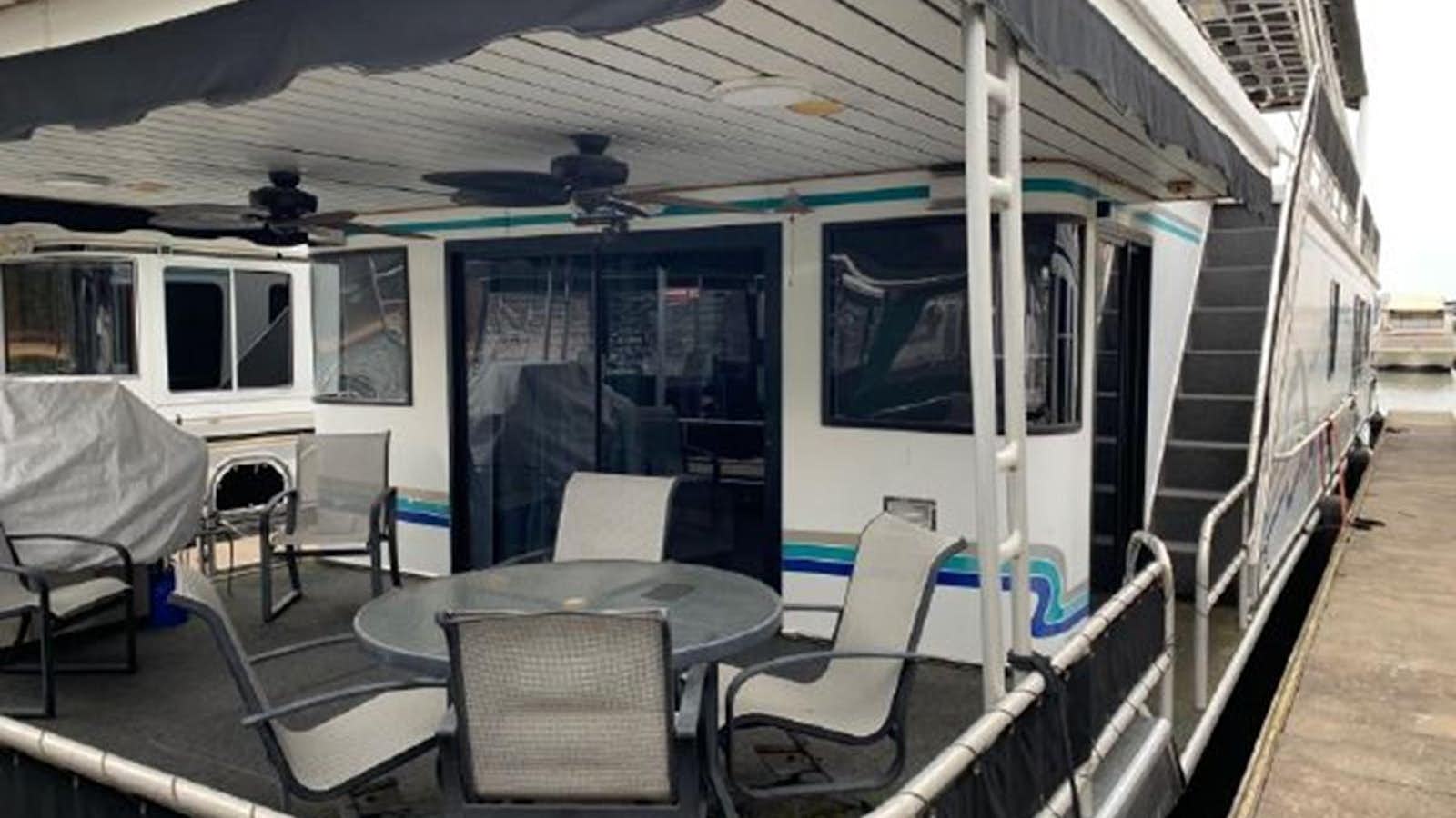 a tram with a table and chairs aboard SUMERSET HOUSEBOAT Yacht for Sale