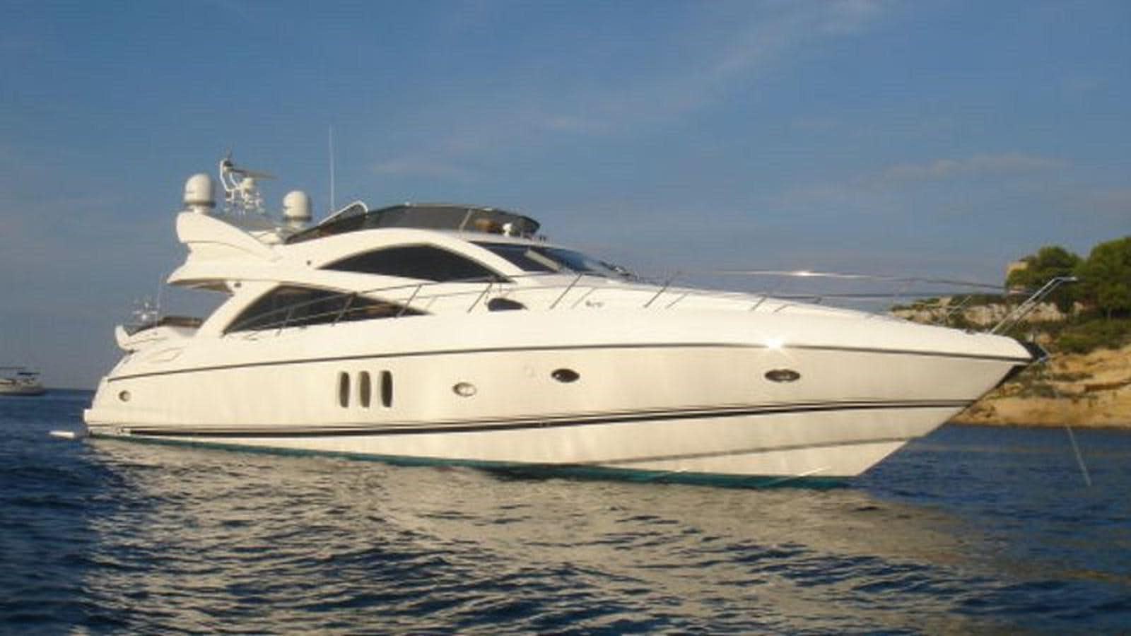 a white yacht on the water aboard PURA VIDA Yacht for Sale