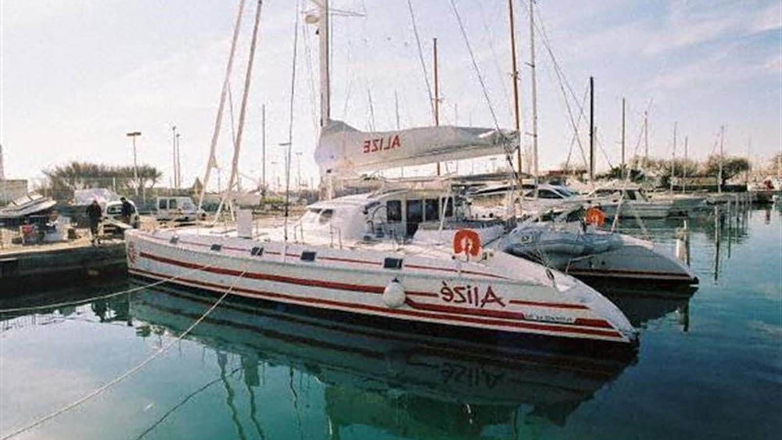 a couple of boats sit in a harbor aboard 64' 2002 OUTREMER 64 "ALIZE Yacht for Sale