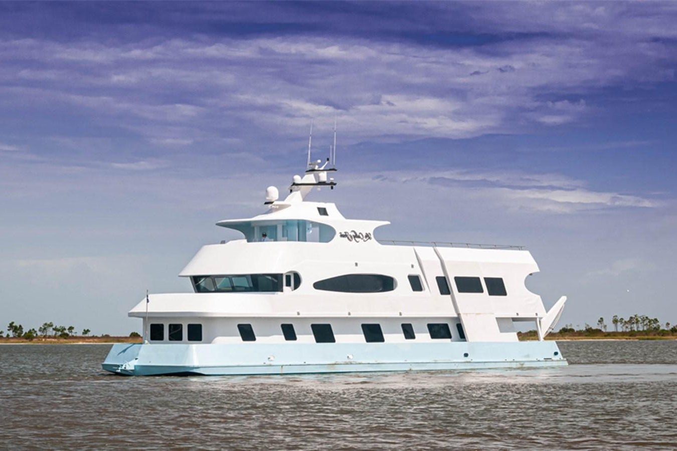 a white boat on a beach aboard LE COLBY JEAN Yacht for Sale
