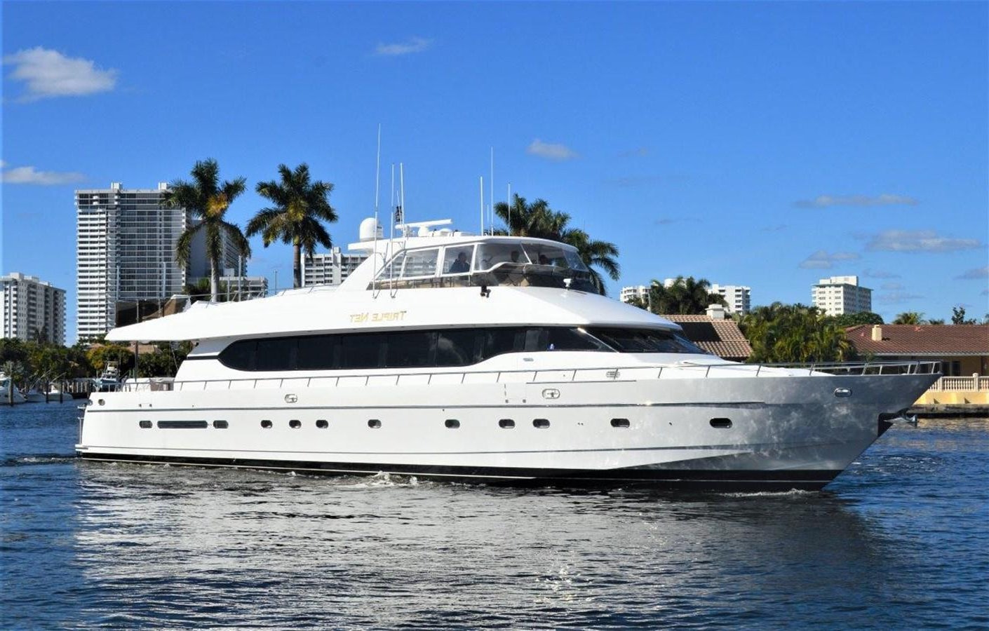 a white yacht in the water aboard TRIPLE NET Yacht for Sale
