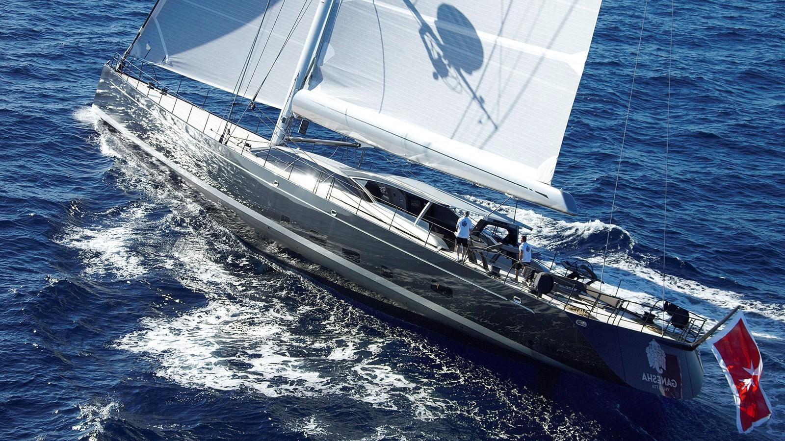 a boat with a flag on it aboard SAGITTA Yacht for Sale