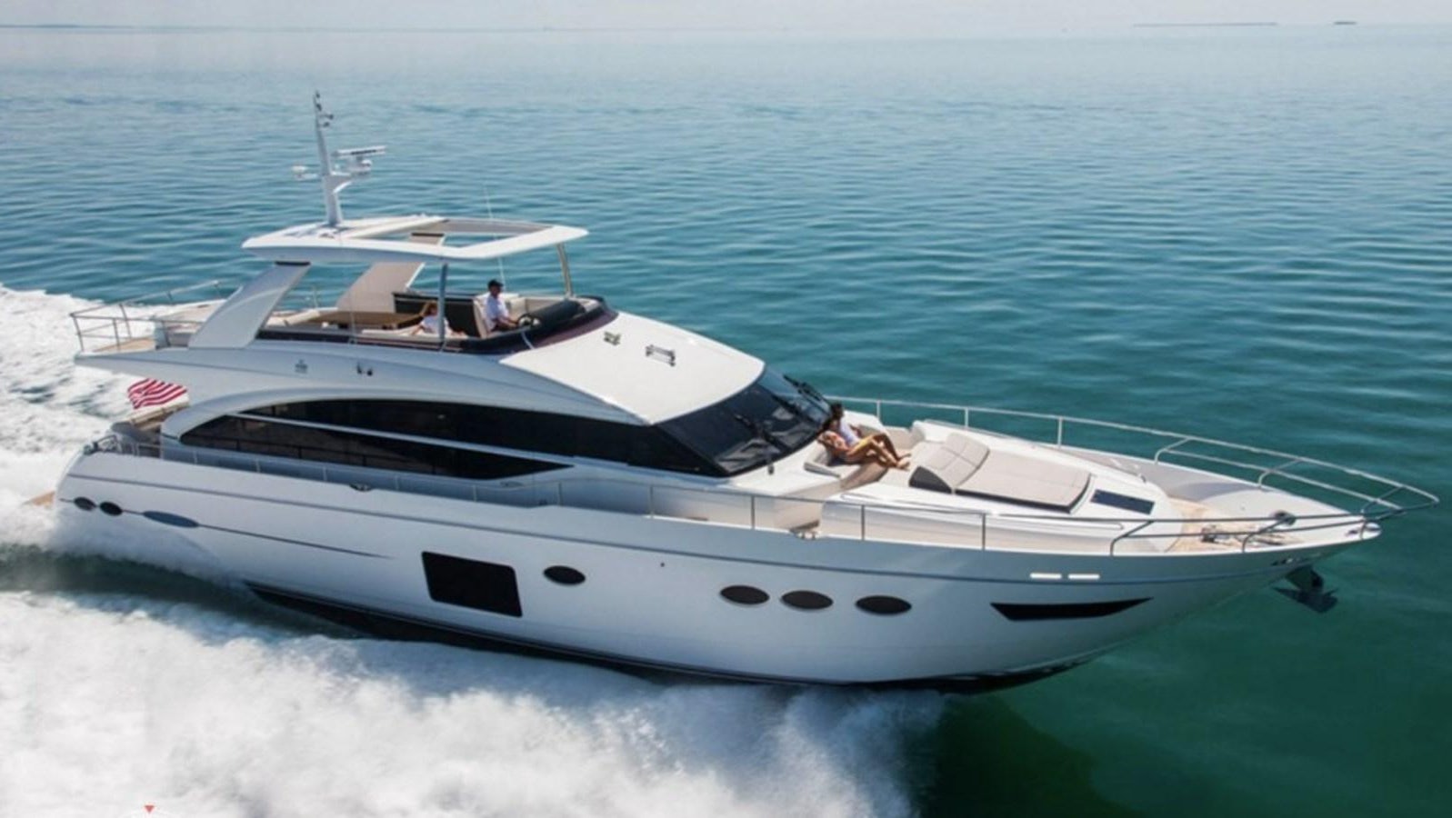 a white yacht on the water aboard ANOTHER TOY Yacht for Sale