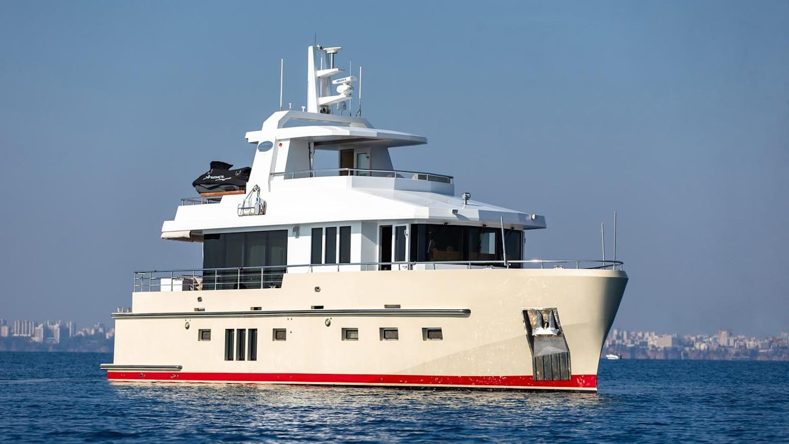 a large white boat on the water aboard DZAM Yacht for Sale