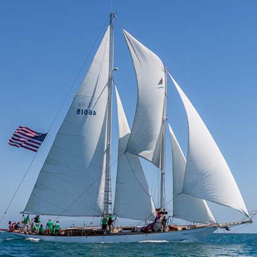 a sailboat with a flag on it aboard CURLEW Yacht for Sale