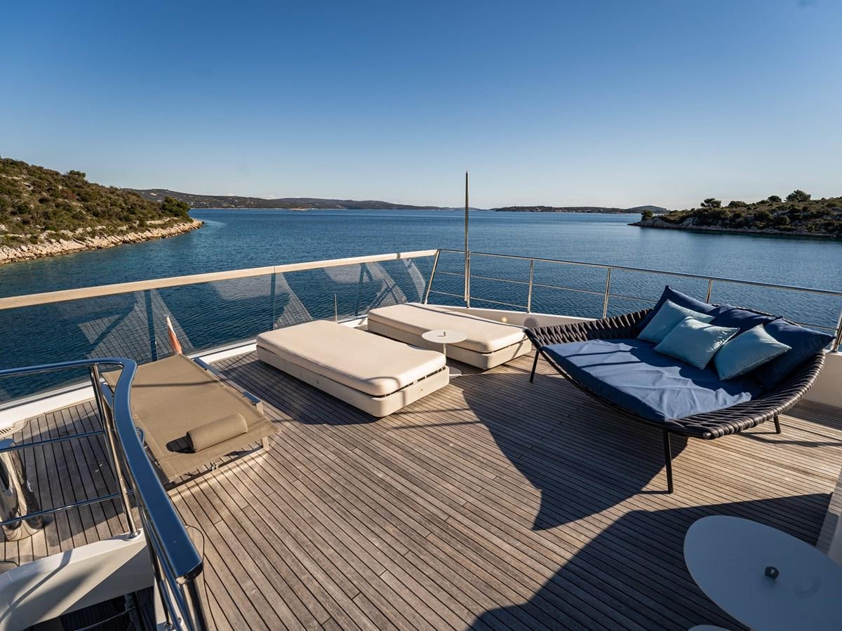 a deck with a pool and a view of the water aboard BONITA II Yacht for Sale