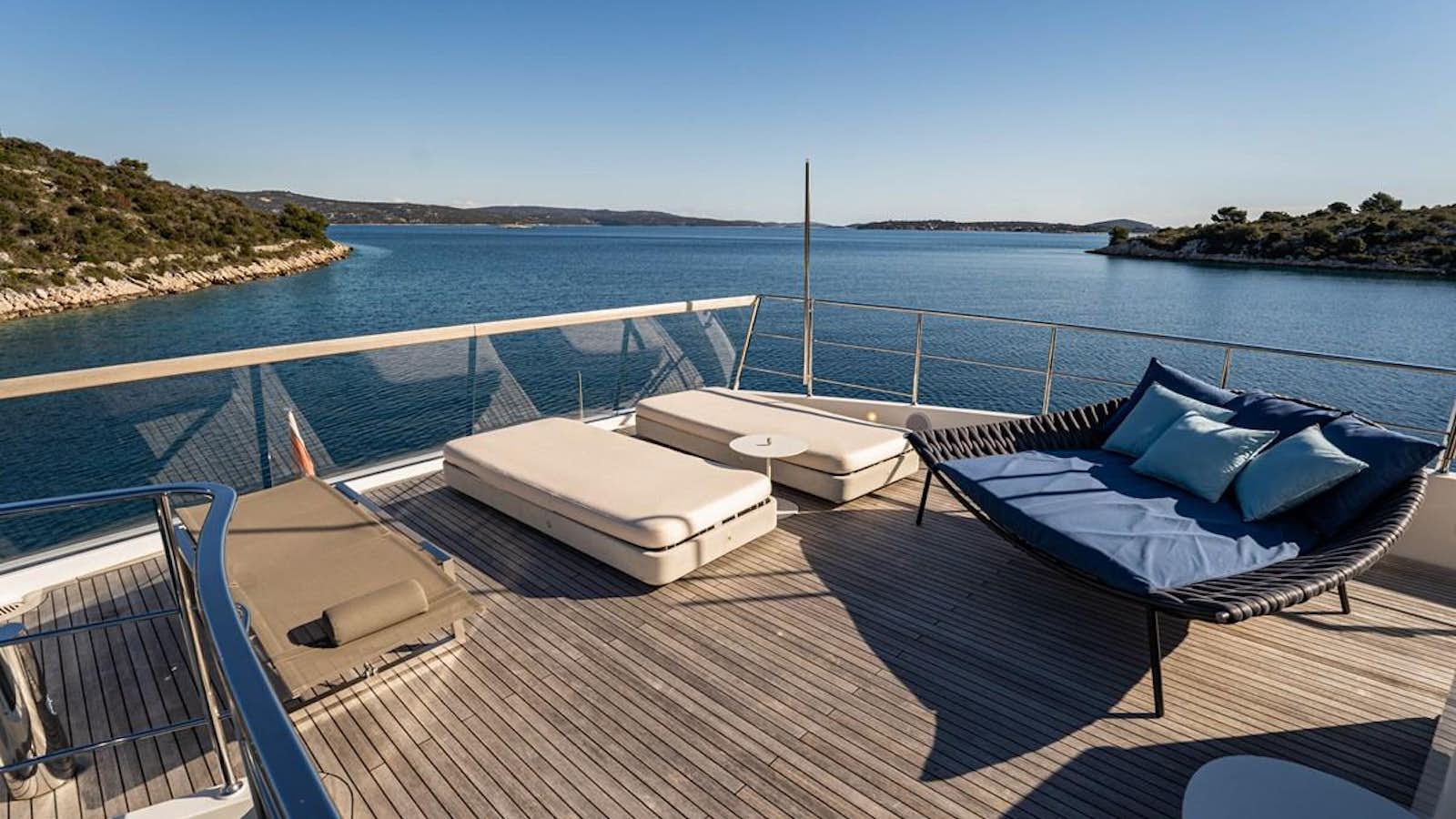 a deck with a pool and a view of the water aboard BONITA II Yacht for Sale