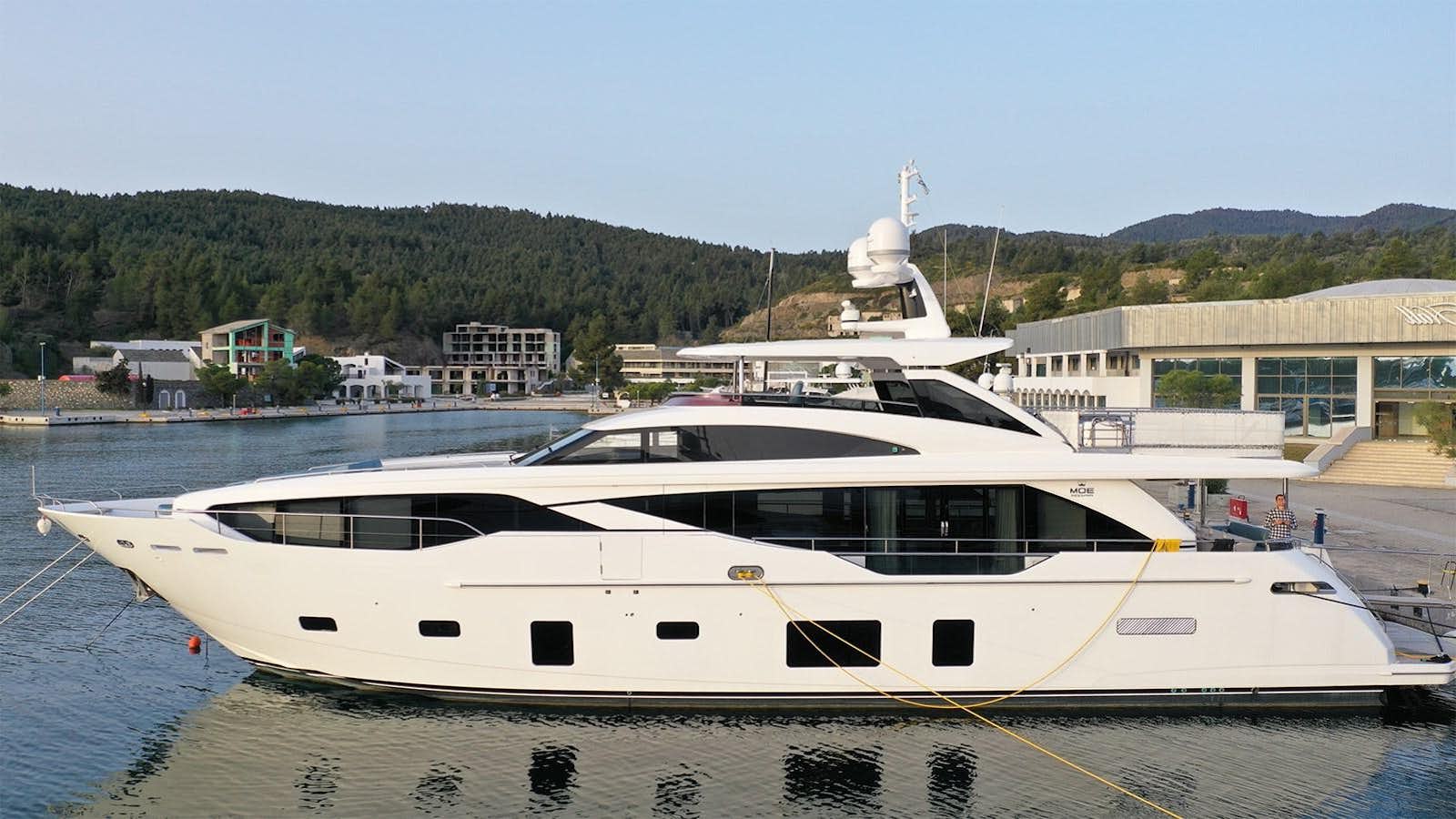 a white yacht in a harbor aboard AFON Yacht for Sale