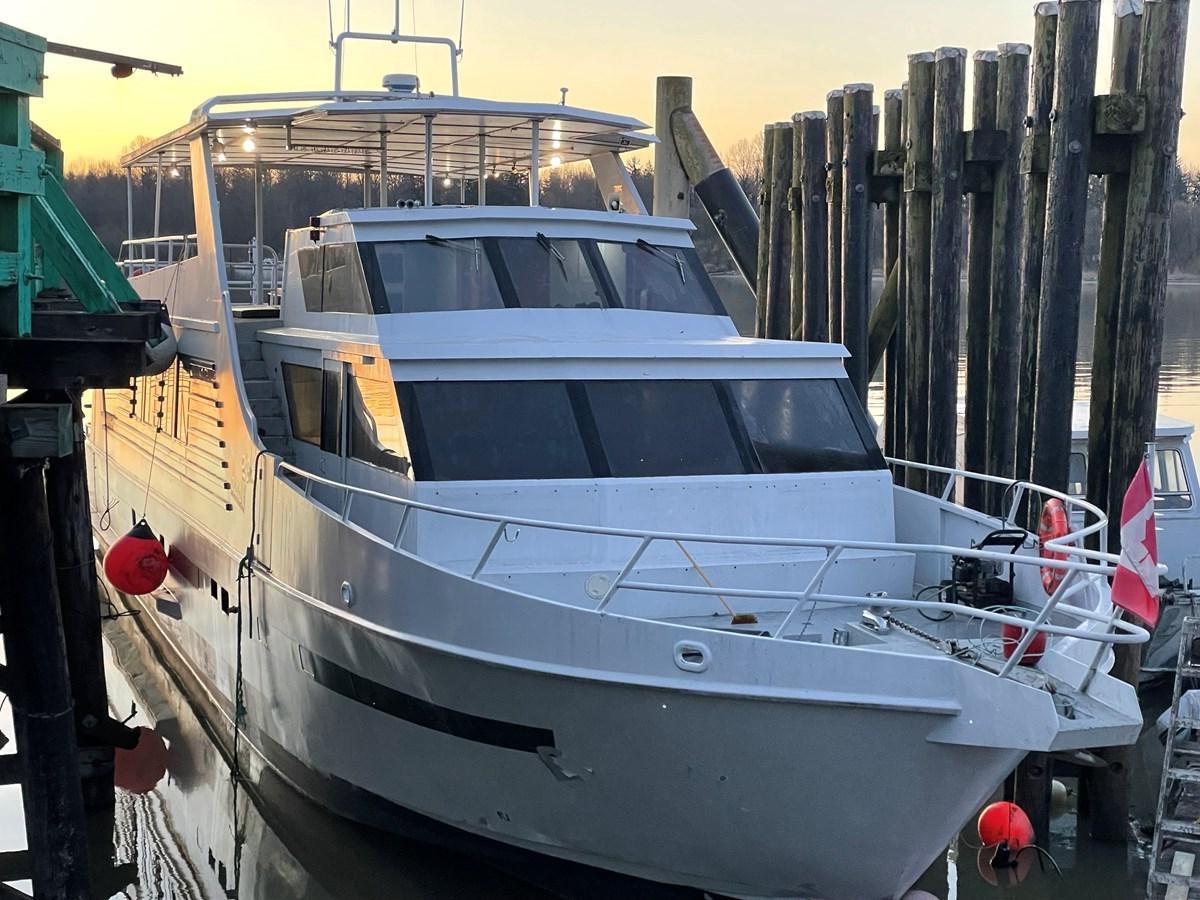 a white boat in a dock aboard MAGIC MOMENT Yacht for Sale