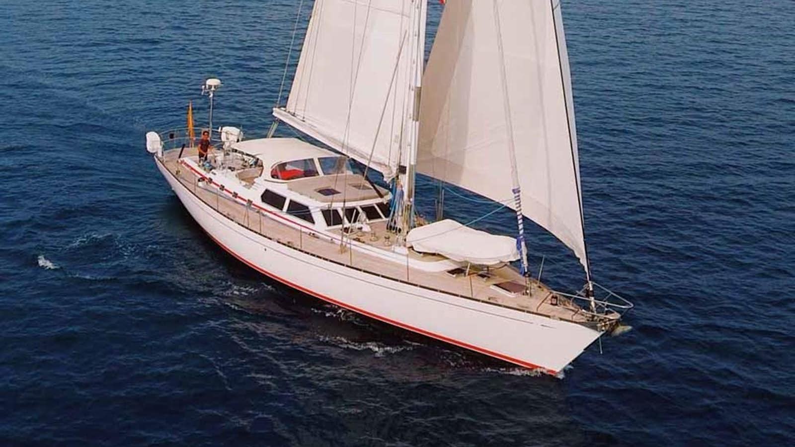a white sailboat on the water aboard PLUM Yacht for Sale