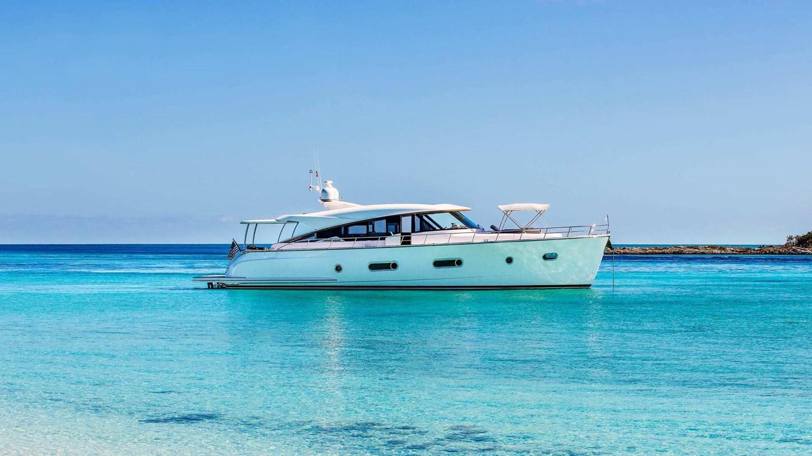 a white boat in the water aboard BELIZE 66 SEDAN Yacht for Sale