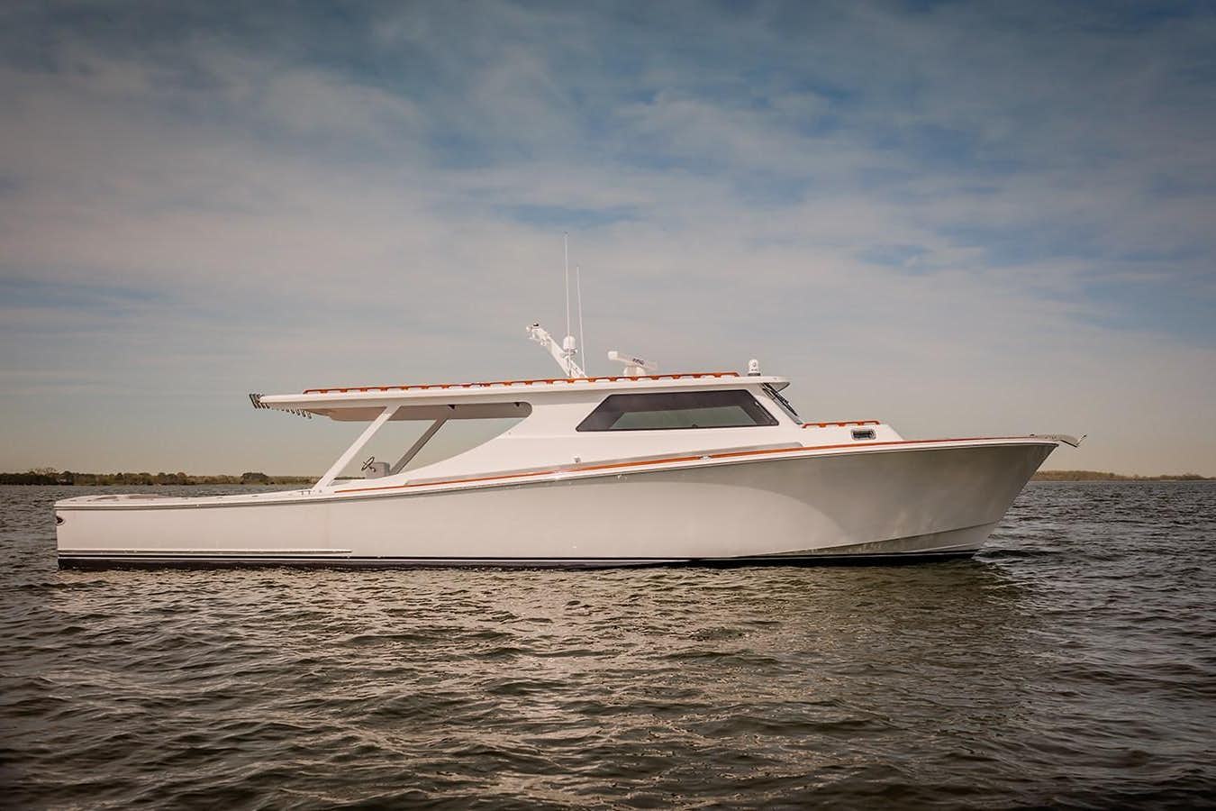 a white boat on the water aboard CY55 Yacht for Sale