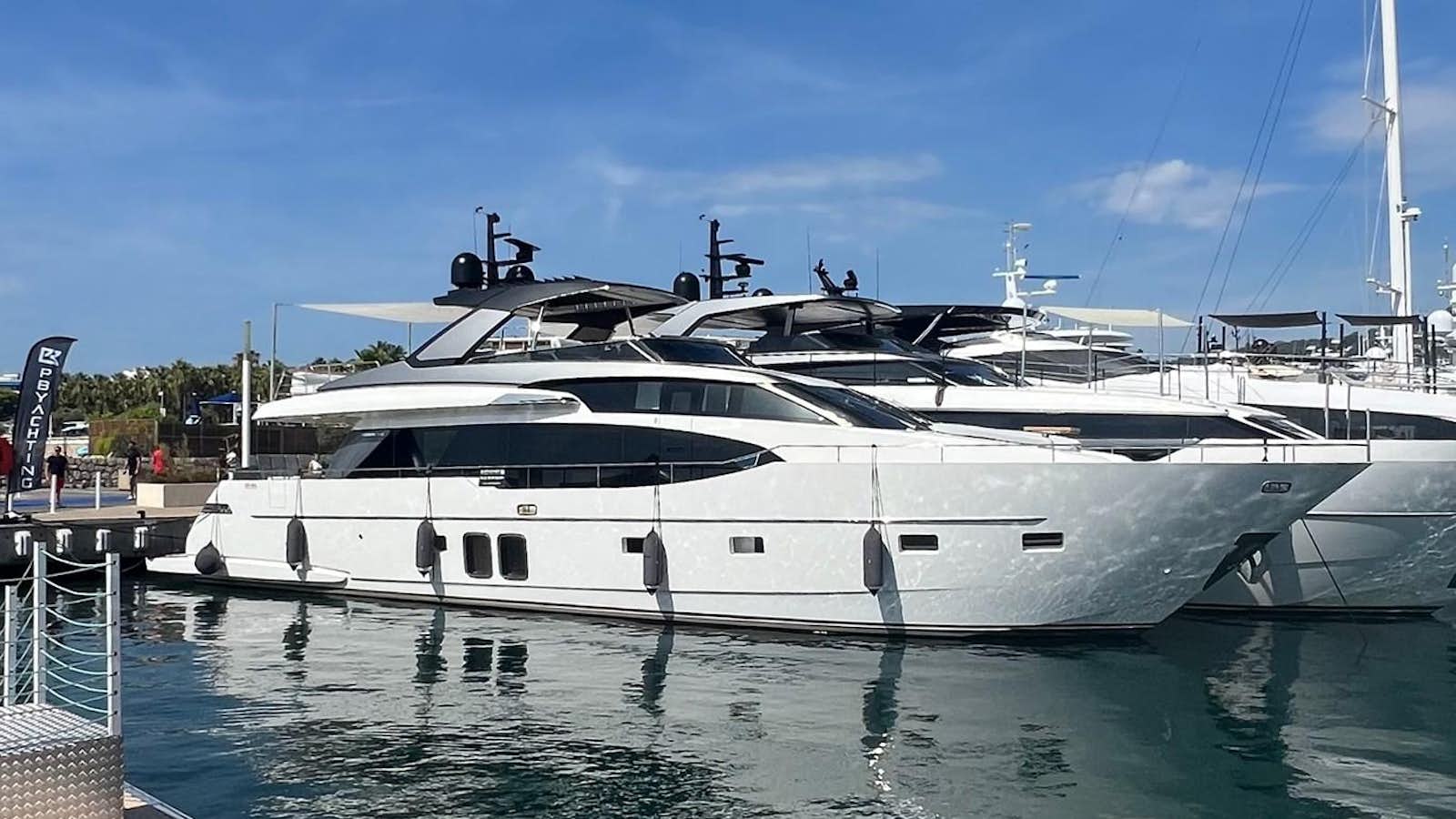 a white yacht docked at a pier aboard SANLORENZO SL78/815 Yacht for Sale