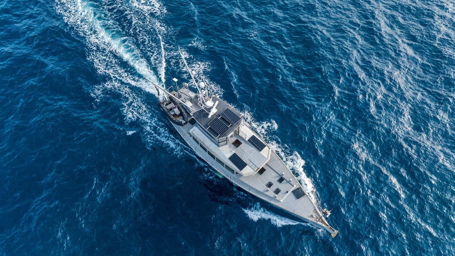 a military ship in the ocean aboard KAIZEN Yacht for Sale
