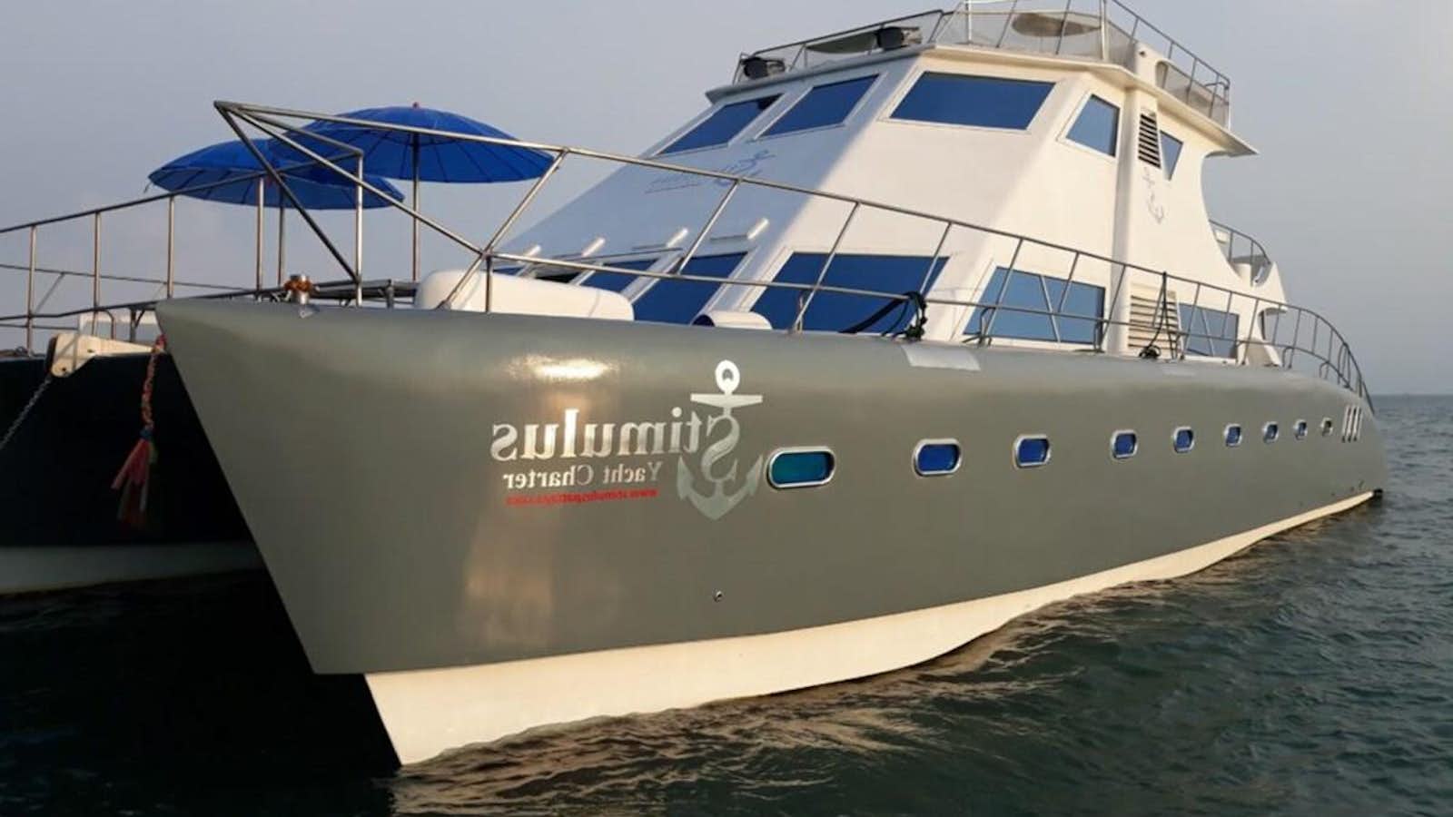 a large white boat on the water aboard STIMULUS Yacht for Sale