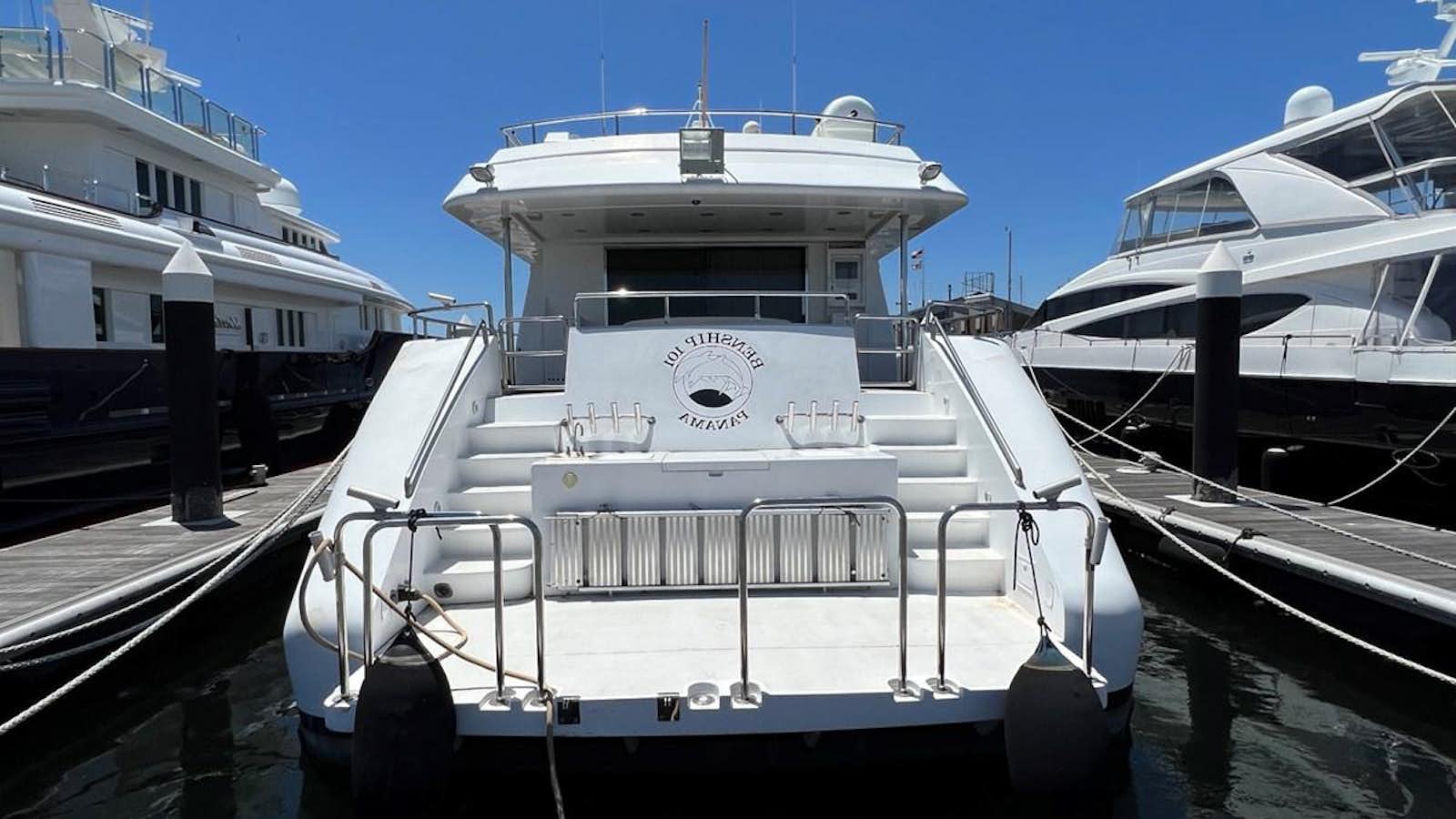 a large white boat sits in a harbor aboard BENSHIP 101 Yacht for Sale