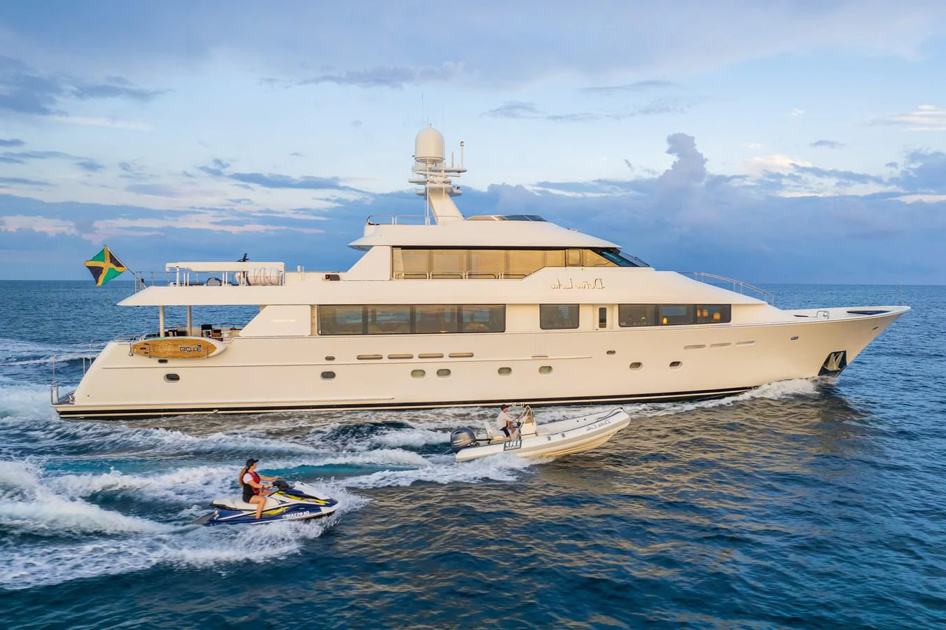 a large white ship with a couple of people in it aboard DONA LOLA Yacht for Sale