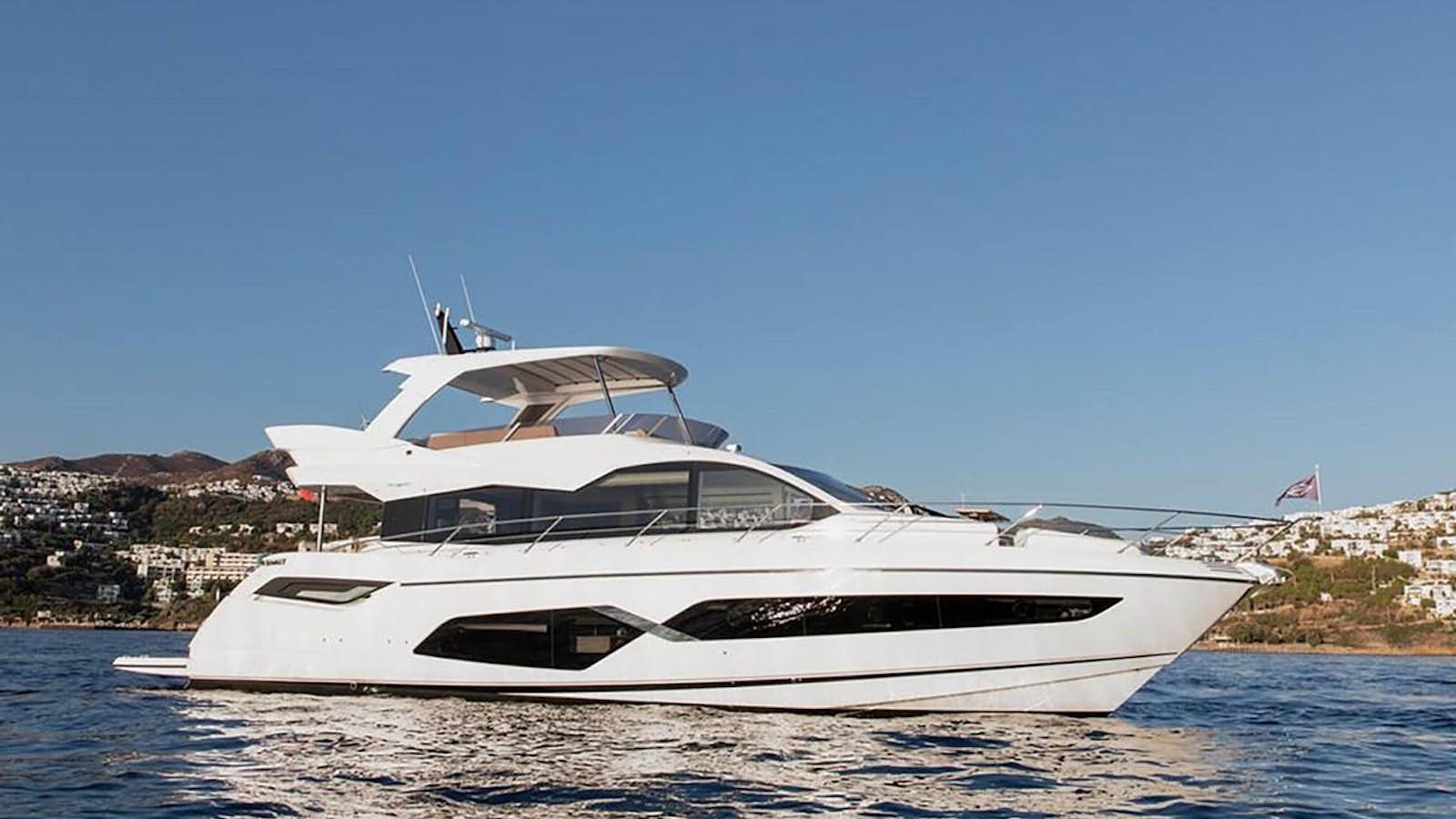 a white yacht on the water aboard SUNSEEKER 70' MANHATTAN Yacht for Sale
