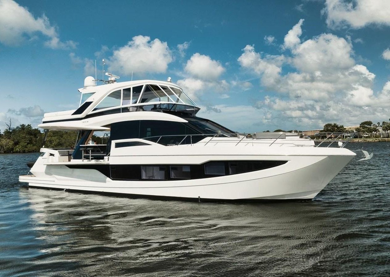 a white yacht on the water aboard JUST IN TIME Yacht for Sale