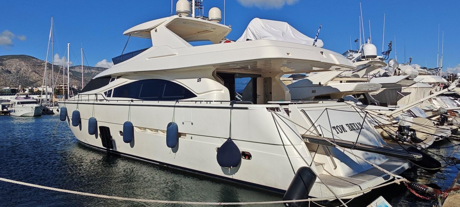 a white yacht on the water aboard MAYBE NOT Yacht for Sale