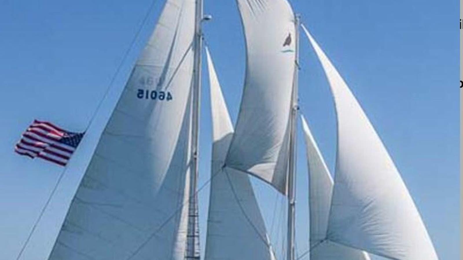 a sailboat with a flag on it aboard CURLEW Yacht for Sale