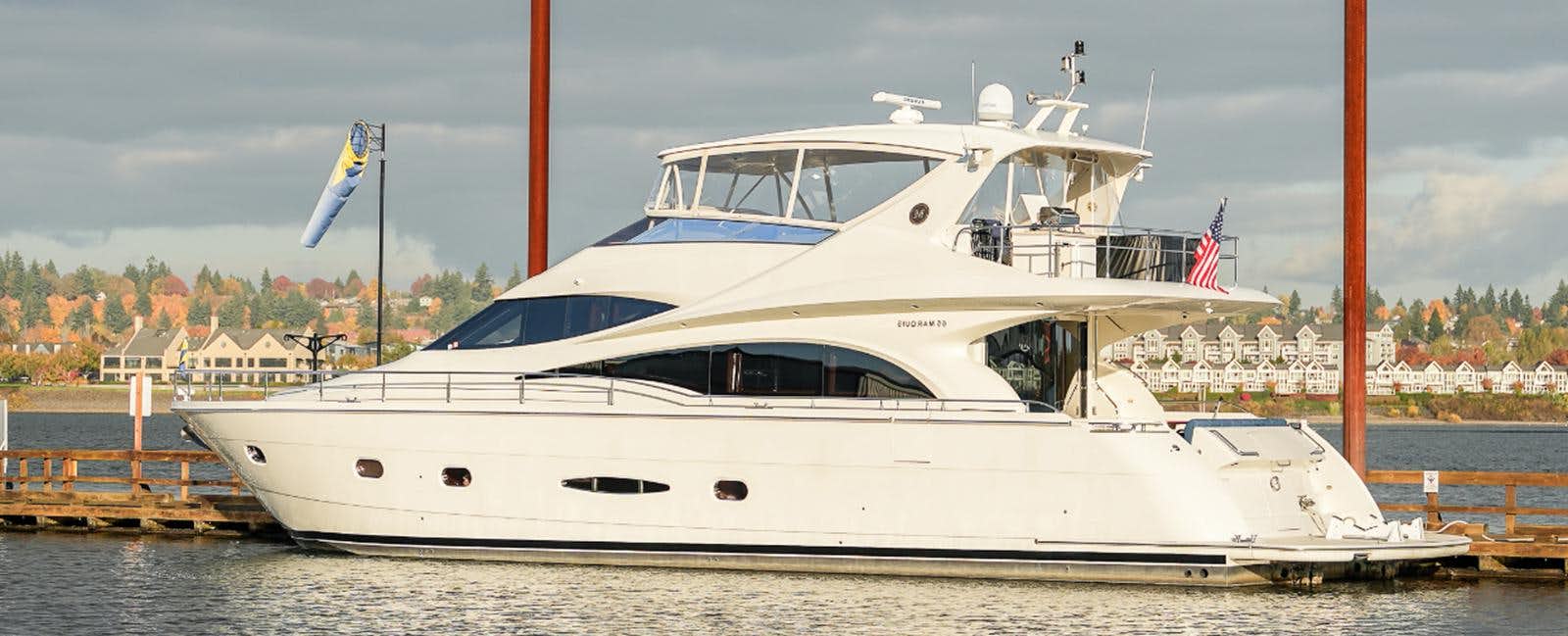 a white yacht on the water aboard 2006 MARQUIS 65 Yacht for Sale