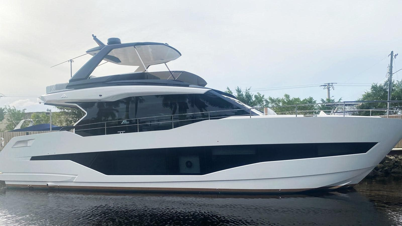 a white yacht on a dock aboard ASTONDOA Yacht for Sale