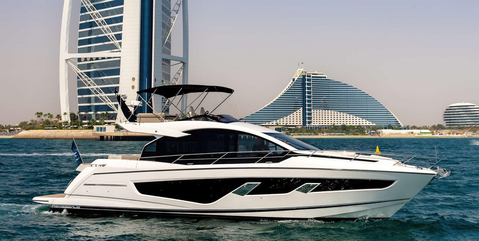 a white yacht in front of a building aboard SUNSEEKER 65 SPORTS Yacht for Sale