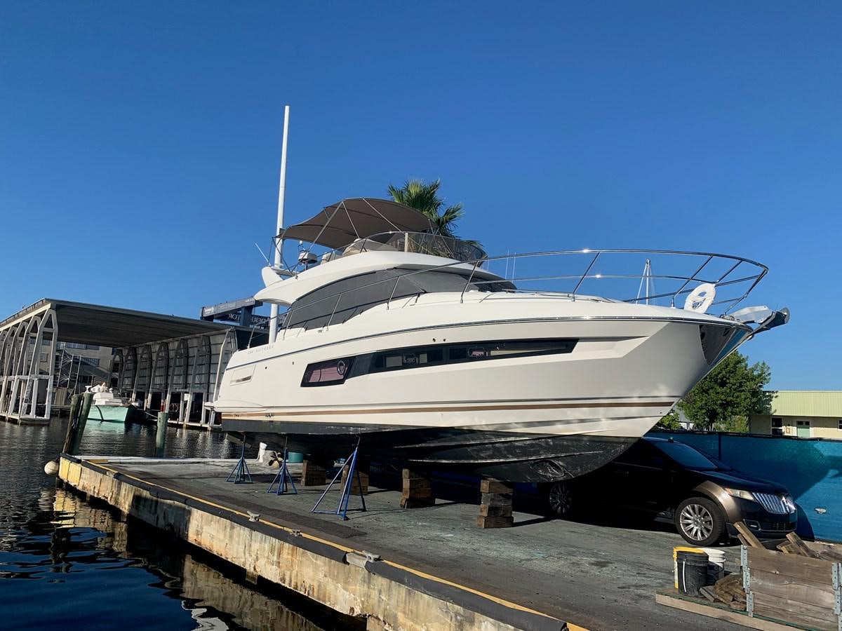 a white yacht docked at a pier aboard OPUS ONE Yacht for Sale
