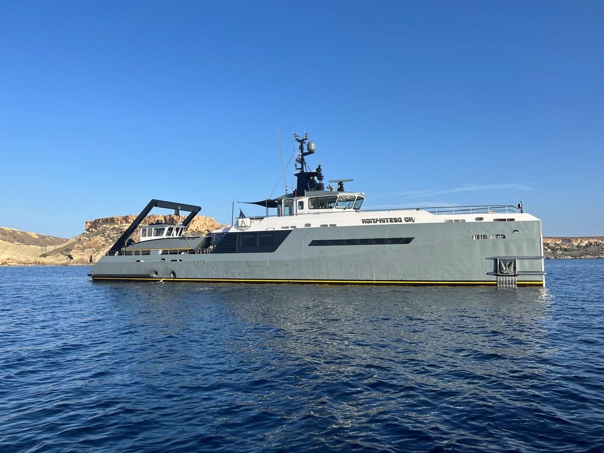 a large white boat in the water aboard NO DESTINATION Yacht for Sale