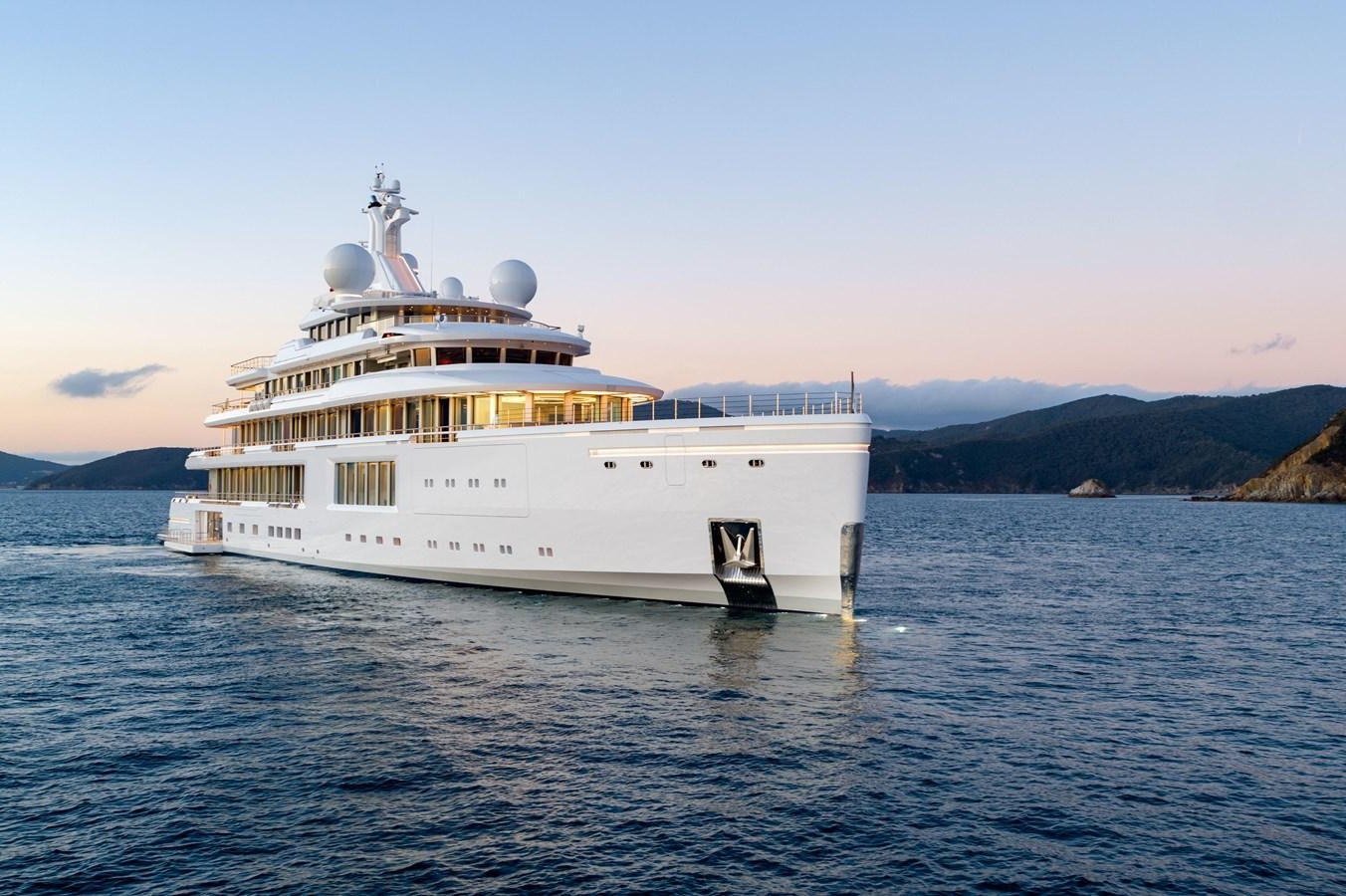 a large white ship in the water aboard LUMINOSITY Yacht for Sale