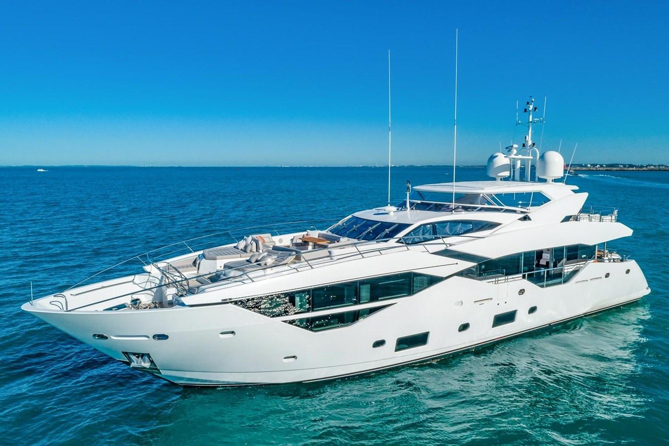 a white yacht in the water aboard POPS Yacht for Sale