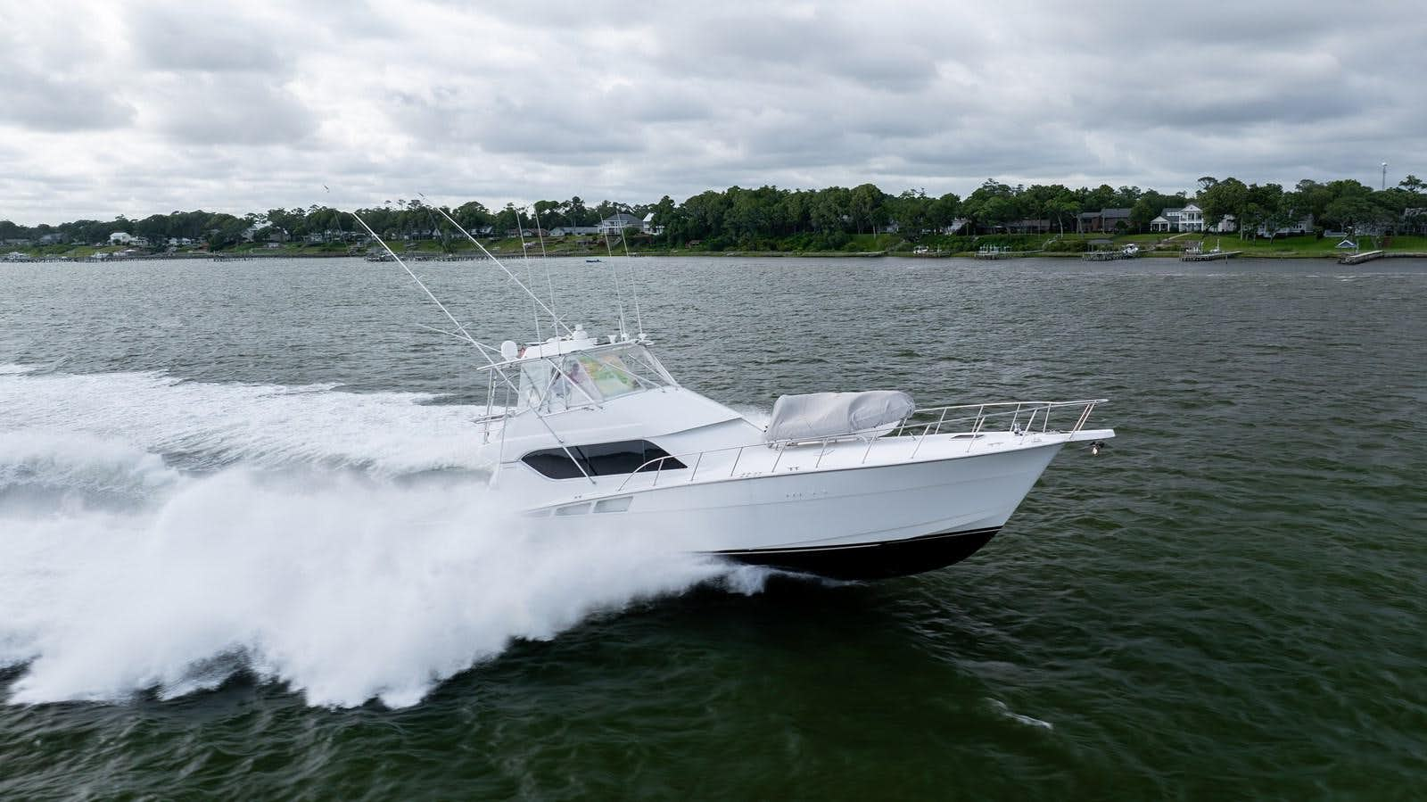 a white boat on water aboard WET HOOKER Yacht for Sale