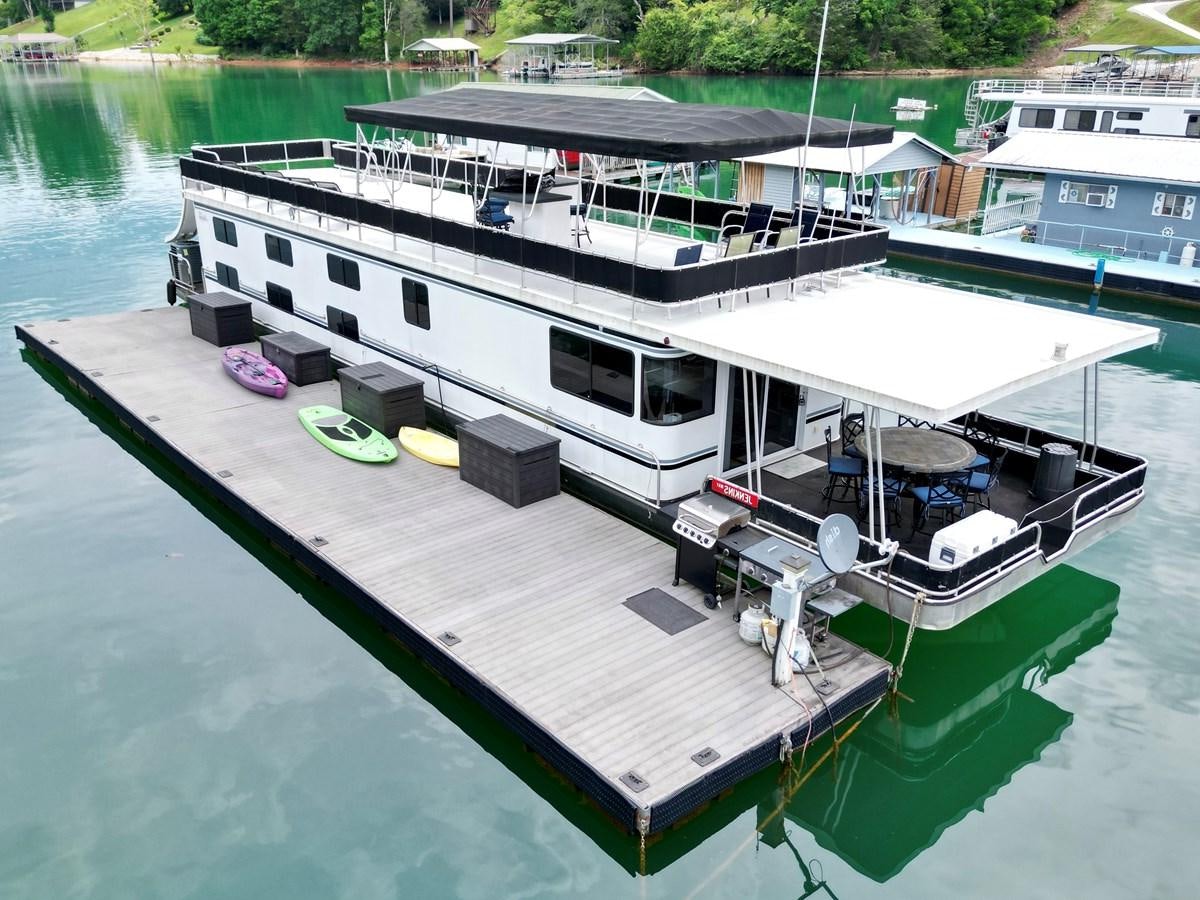a boat docked at a pier aboard 2012 MAJESTIC 16 X 75WB HOUSEBOAT NLSD Yacht for Sale