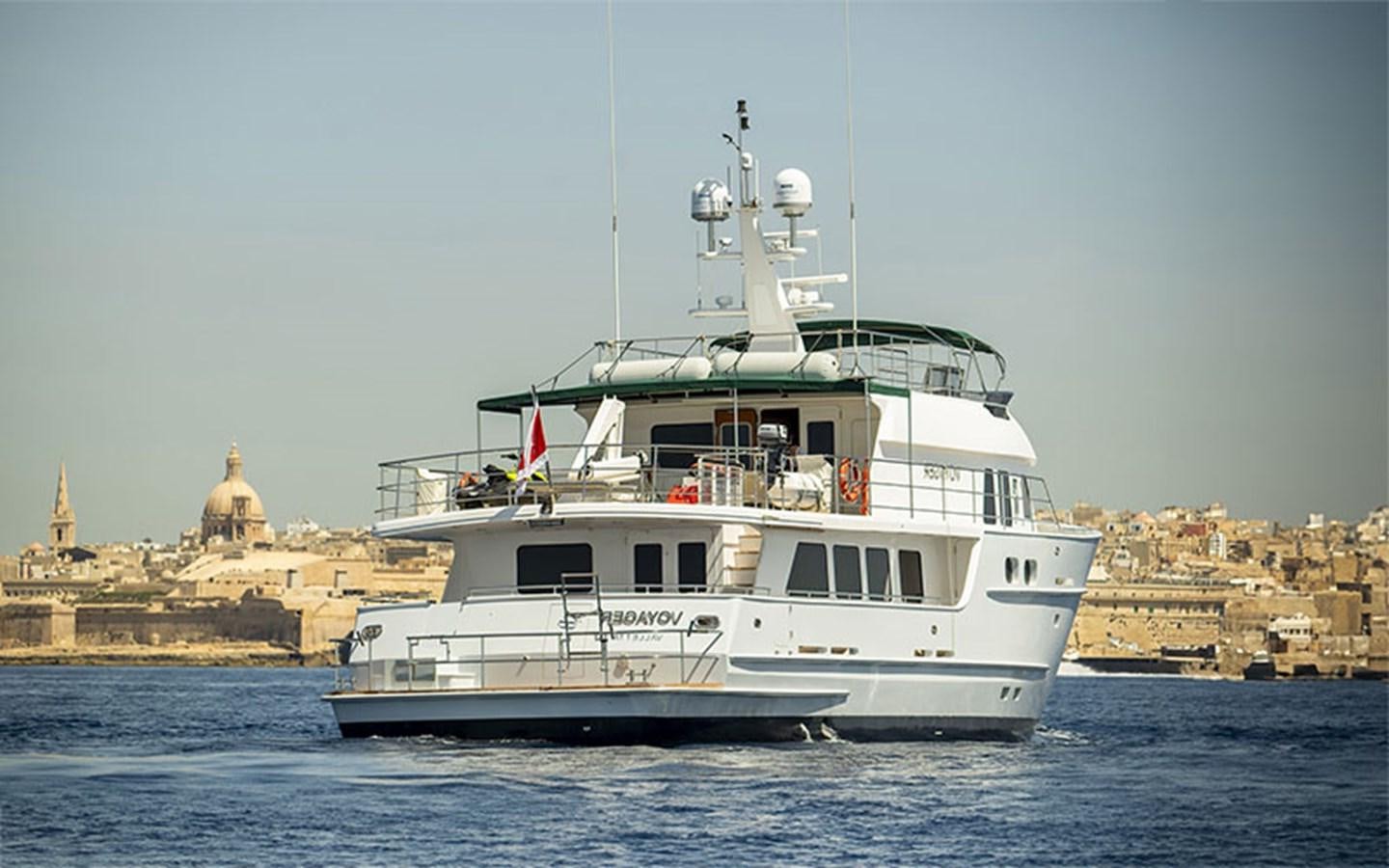 a boat in the water with Thomas Point Shoal Light in the background aboard VOYAGER Yacht for Sale