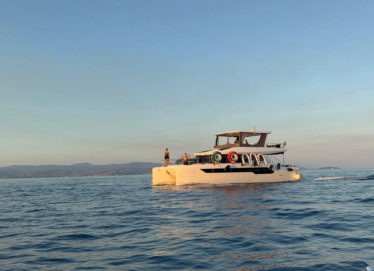 A sleek yacht cruises on calm waters during a serene sunset. aboard LEOPARD 28M Yacht for Sale